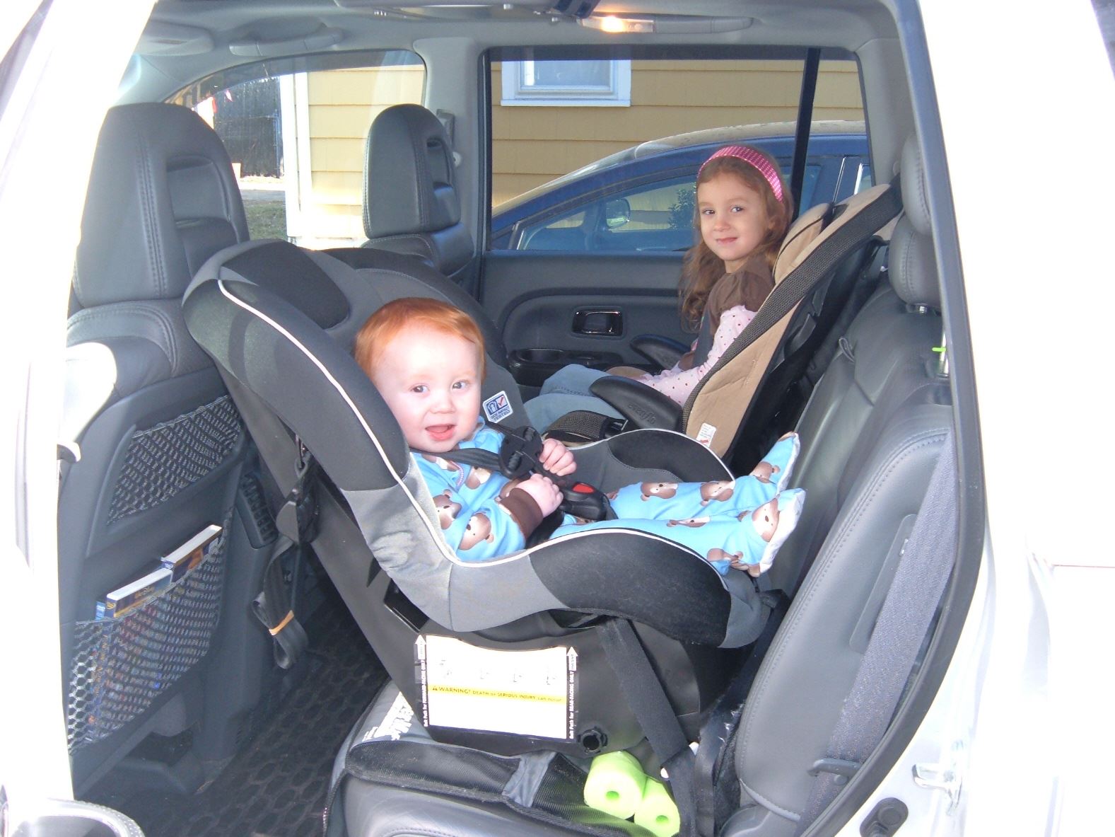 Children in back seat of a vehicle in car seats
